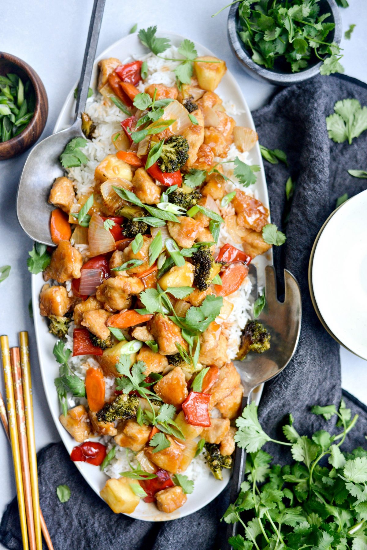 Homemade Sweet and Sour Chicken served on white platter with rice