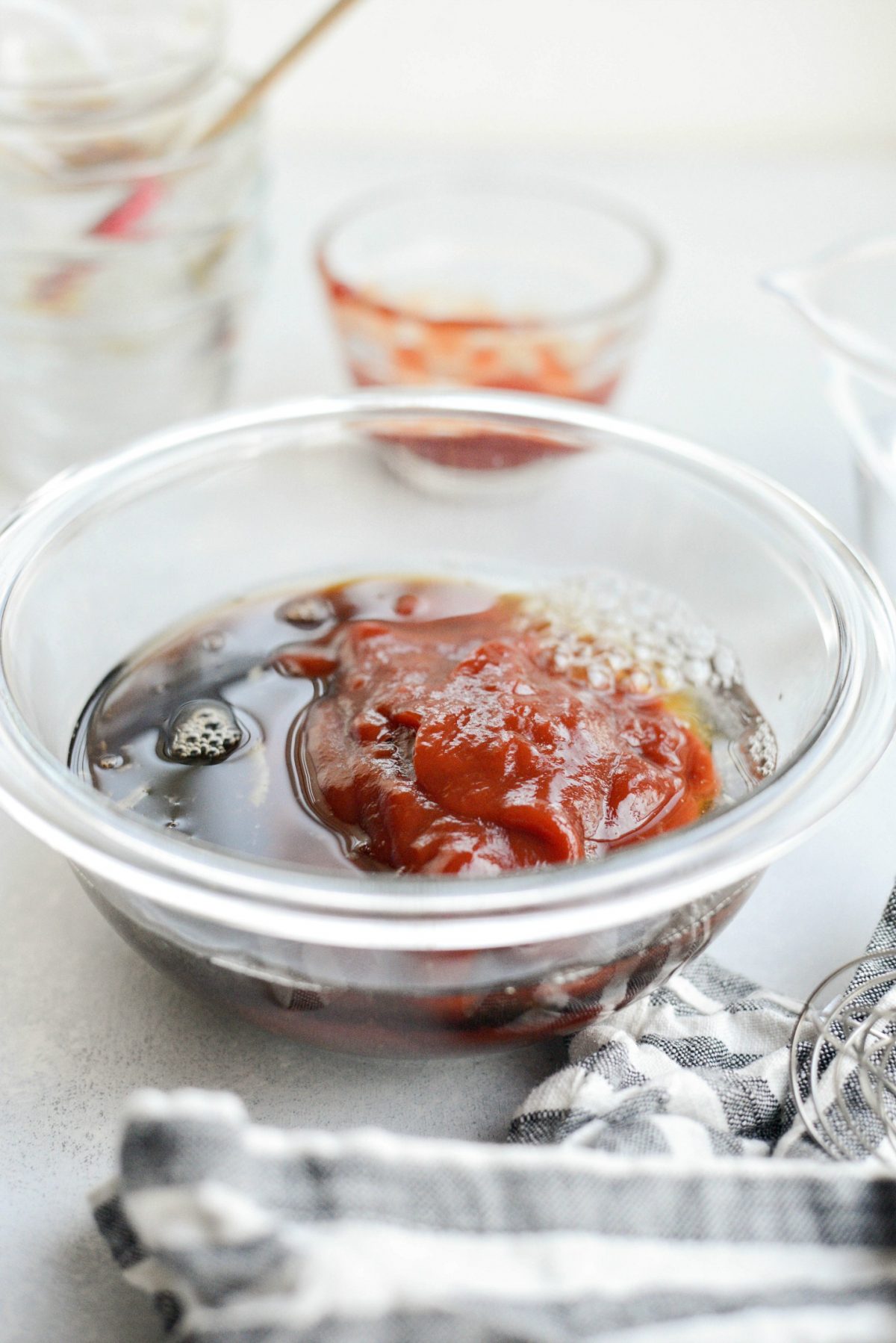 adding ketchup, pineapple juice and low-sodium tamari to glass bowl