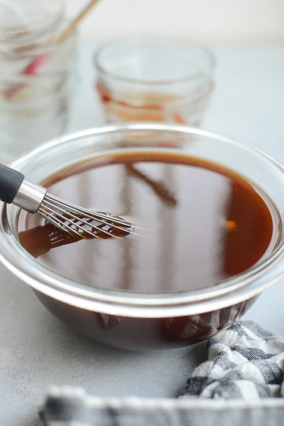glass bowl of Sweet and Sour sauce with whisk