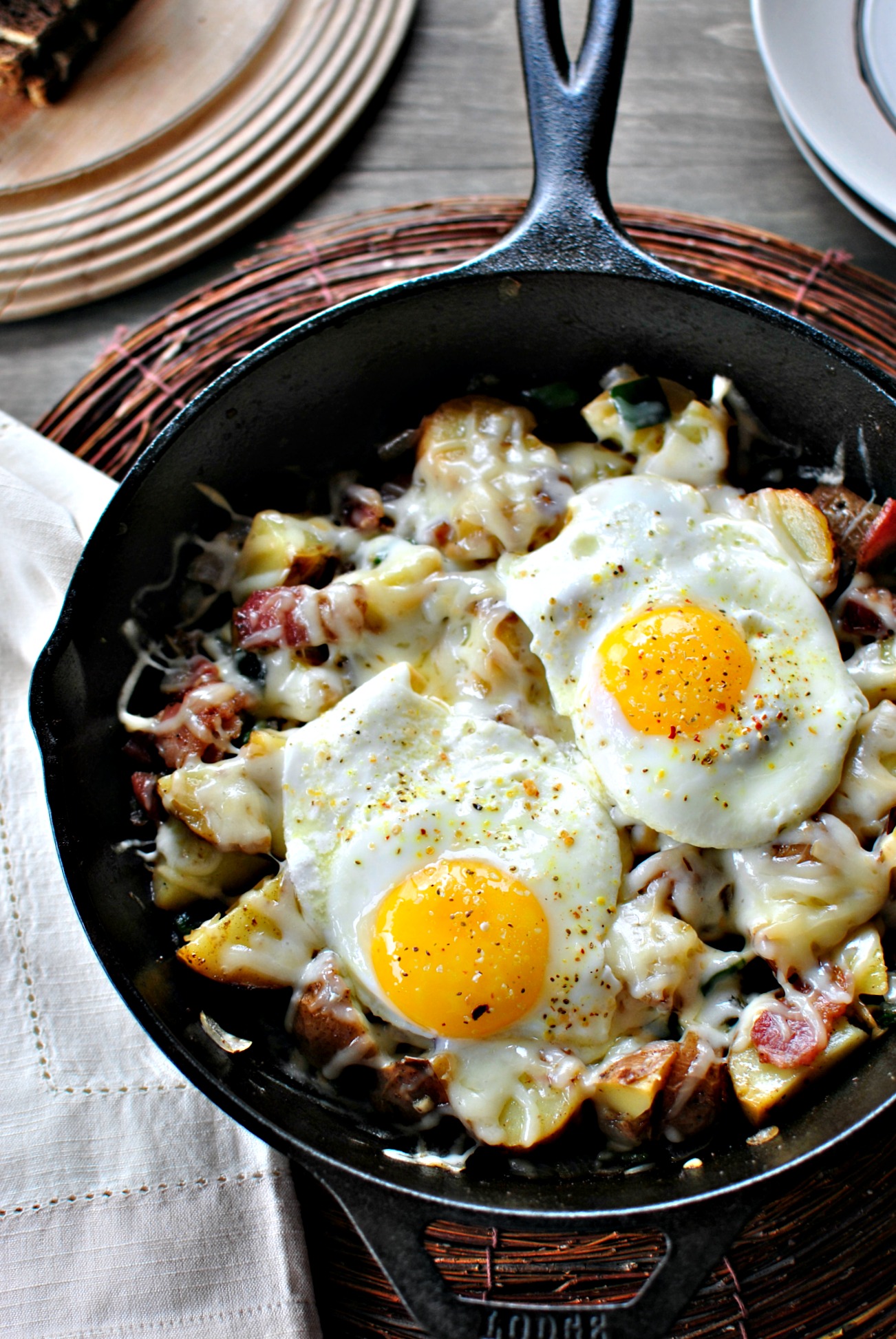 Skillet Baked Eggs with Potatoes and Bacon - Laughing Spatula