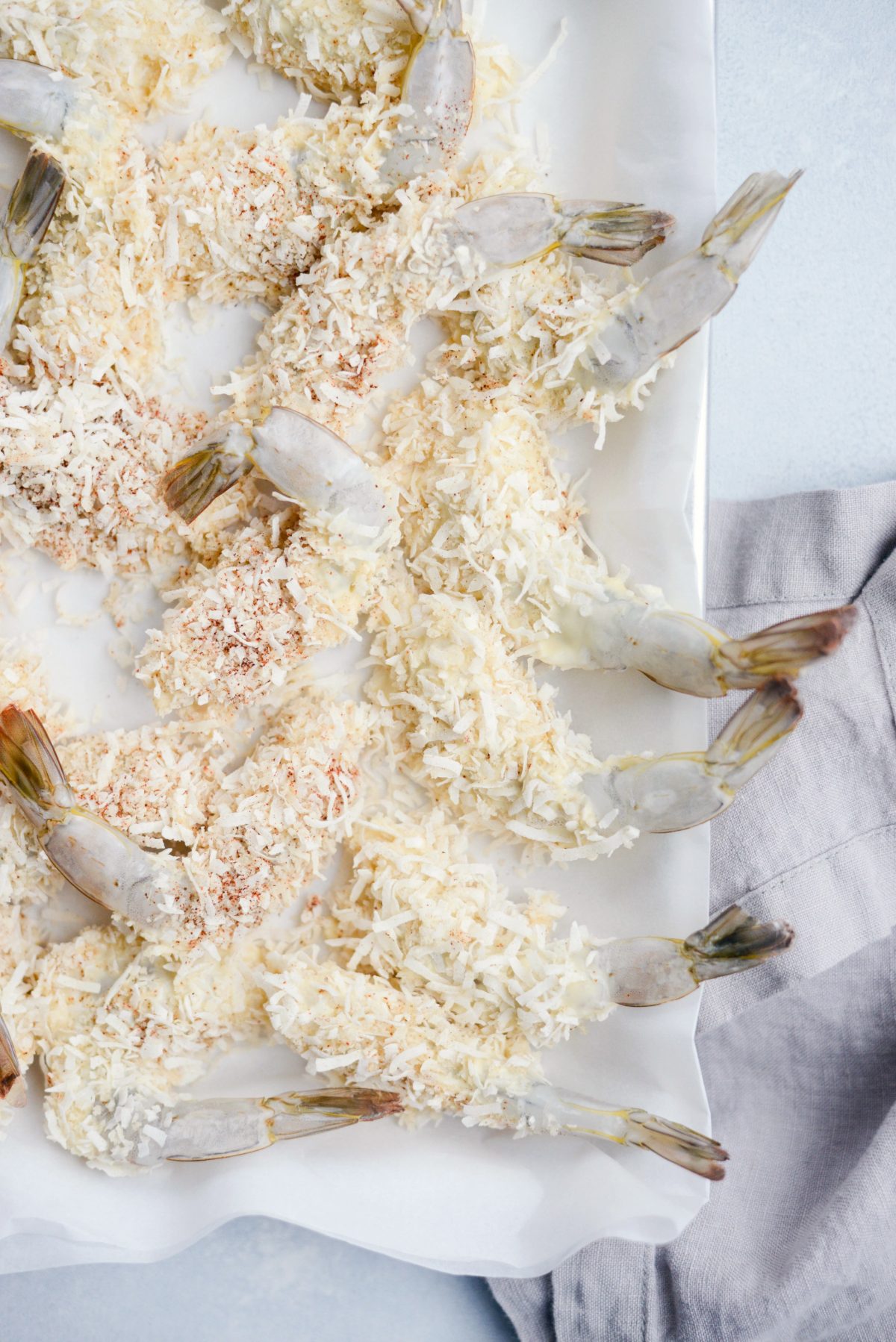 coated shrimp on parchment lined sheet pan