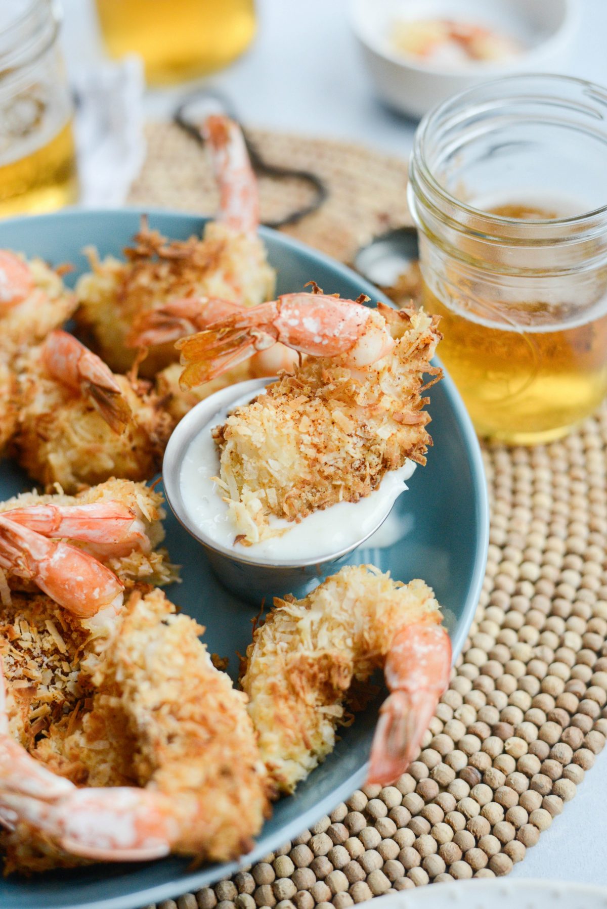 Air-Fryer Coconut Shrimp in small container of Pineapple Coconut Yogurt Dip