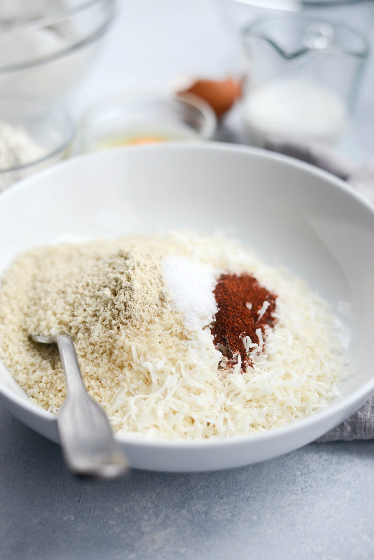 ingredients for coconut breadcrumbs in wide shallow bowl
