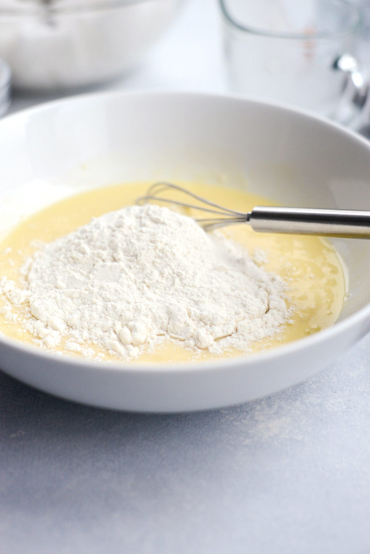 adding flour to batter