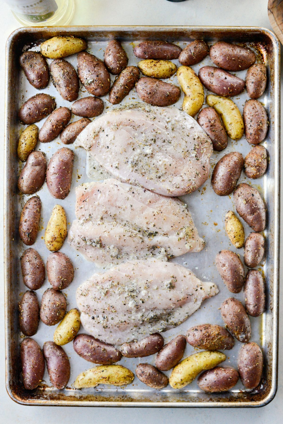 chicken breasts added to pan with potatoes