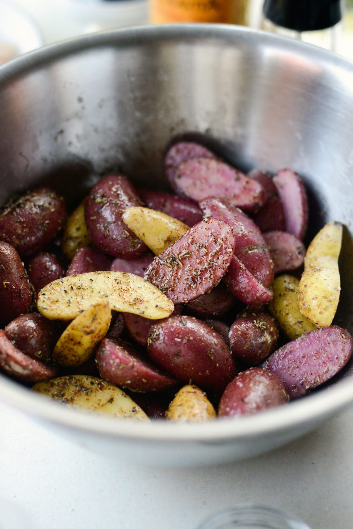 toss potatoes to get coated in oil and herbs and spices