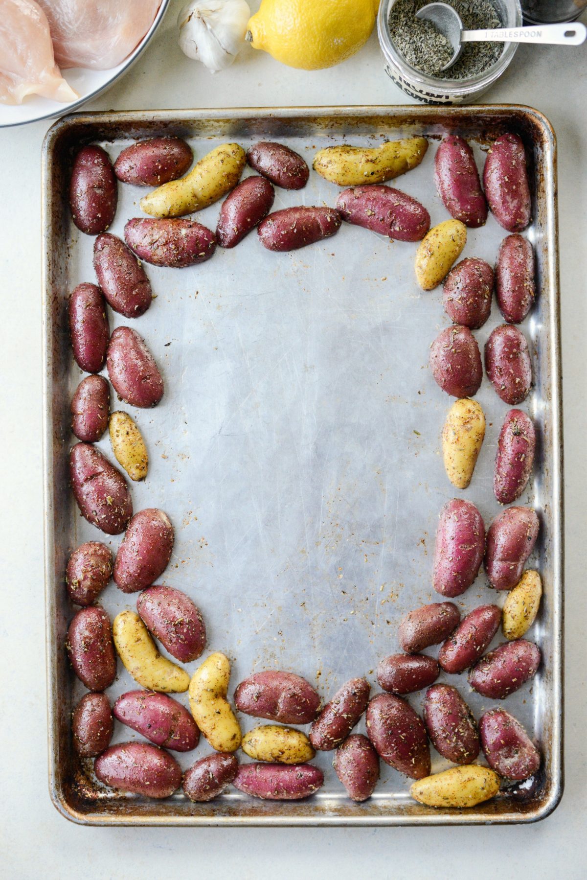 arrange potatoes around the edge of a rimmed metal baking sheet