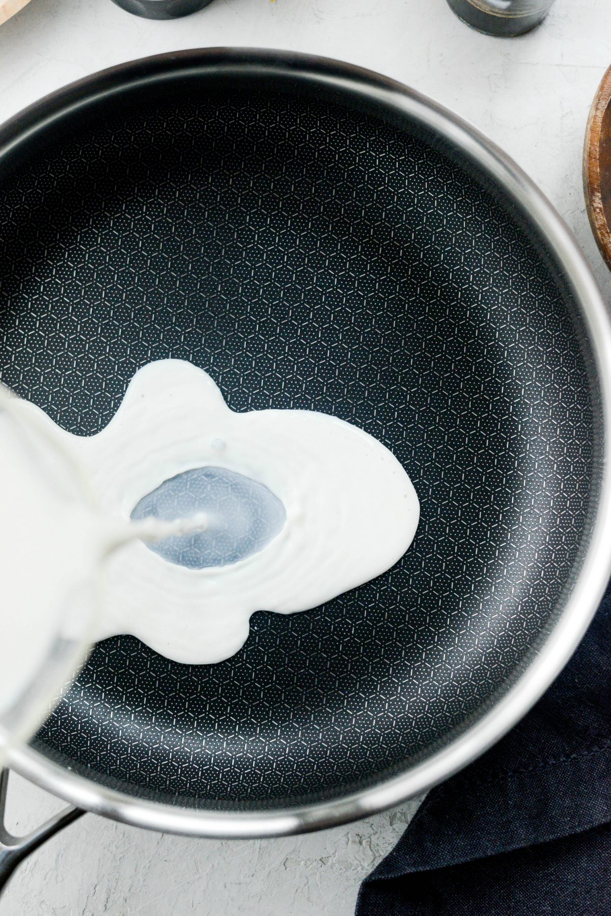 Pour milk and broth into a saucepan or skillet.