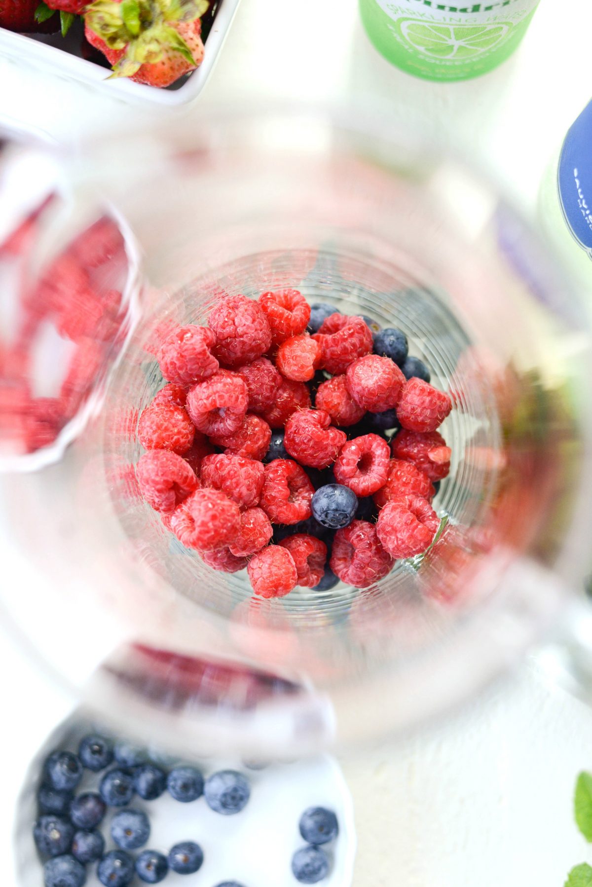 glass pitcher with blueberries and raspberries