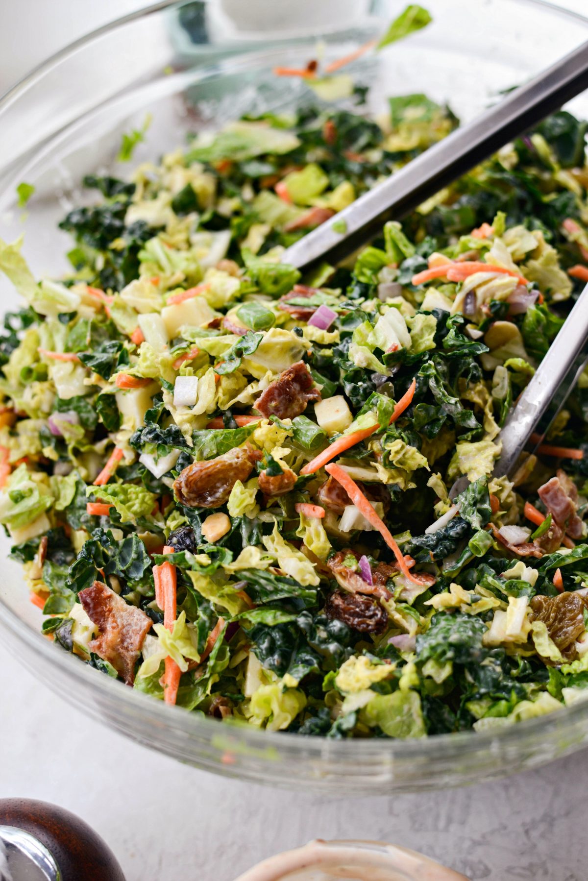 bowl of bbq ranch salad with tongs.