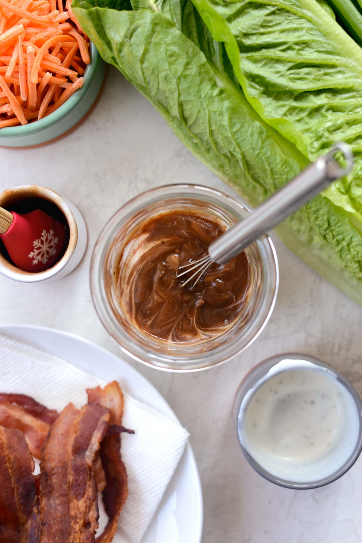 ranch and bbq sauce in a jar with whisk.