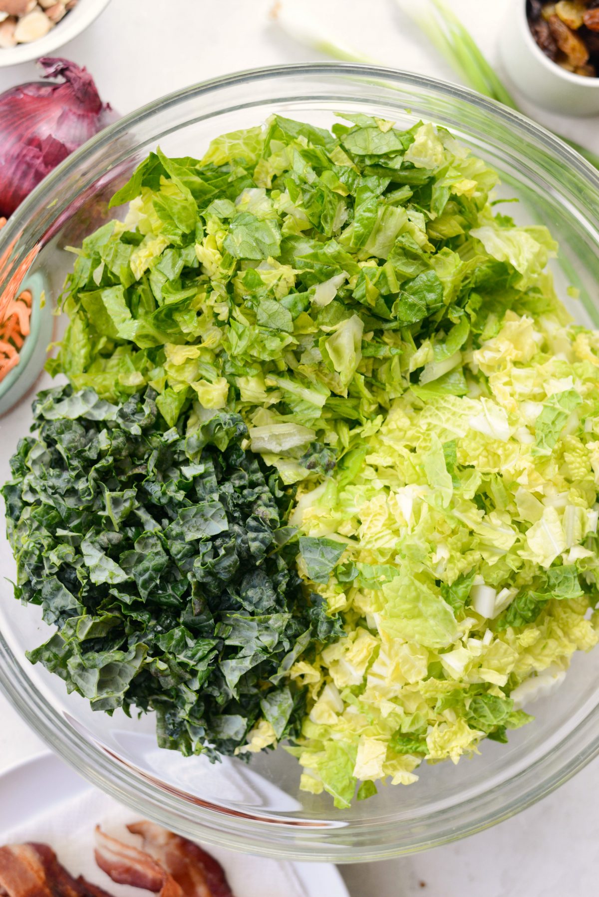 glass bowl of chopped lettuce and kale.