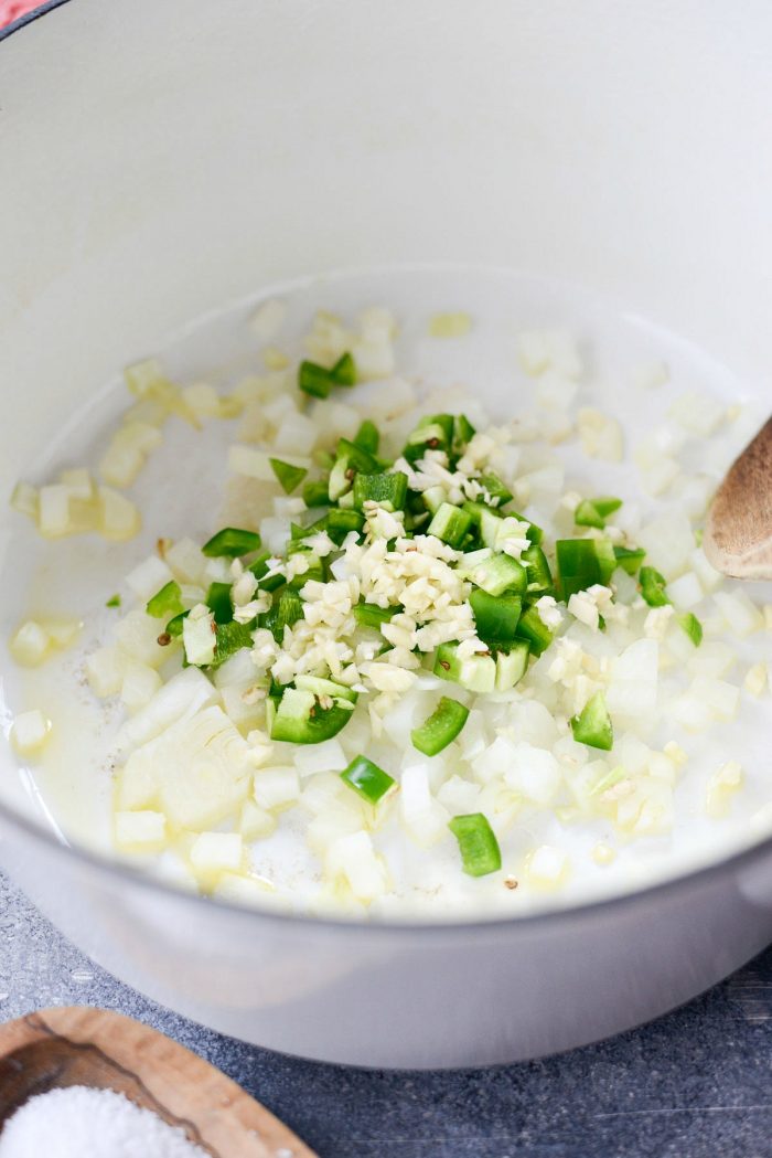 oil, onion, garlic and jalapeños in a pot.