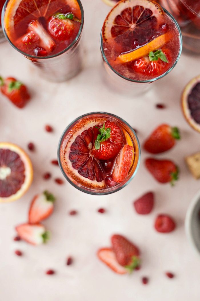 Champagne Sangria l SimplyScratch.com #champagne #sangria #valentinesday #adultbeverage #drink #alcholic #strawberry #pomegranate #raspberry