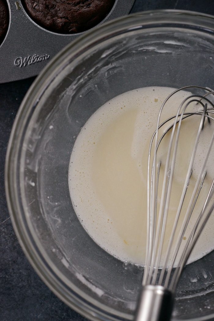 bowl with icing and whisk