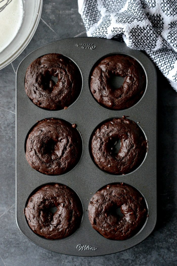 top down shot of baked chocolate cake doughnuts in doughnut pan