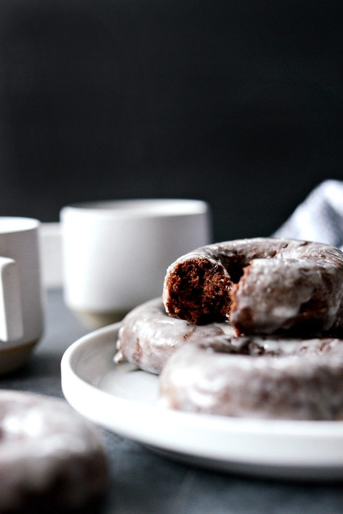 Glazed Chocolate Cake Doughnuts side shot of doughnut bite