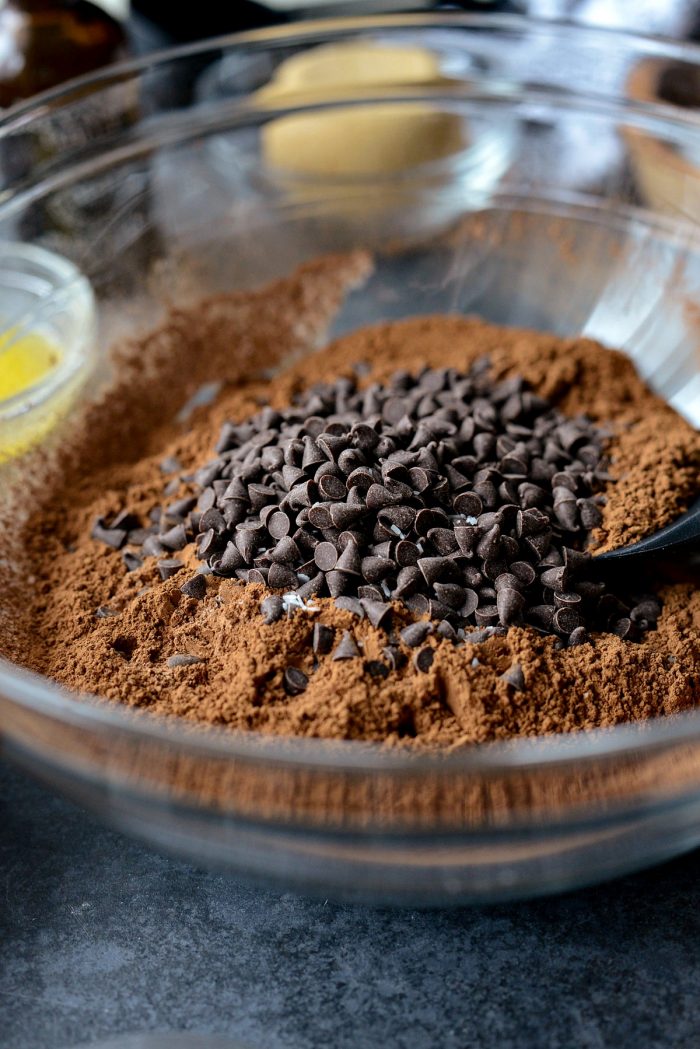 clear bowl with sifted ingredients, brown sugar, mini chocolate chips and kosher salt.