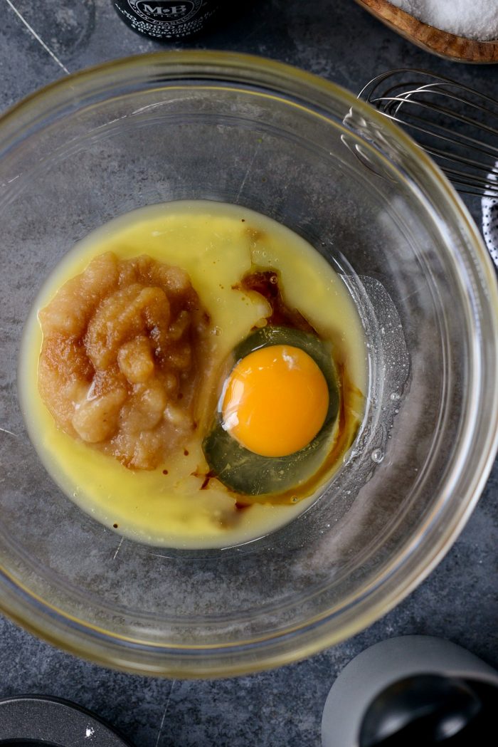 top down photo of bowl with egg, apple sauce, melted butter and vanilla.