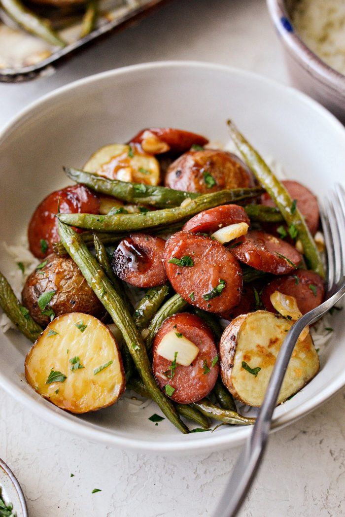 Honey Barbecue Sausage Sheet Pan Dinner - front facing photo with sausage, potatoes and green beans over white long grain rice