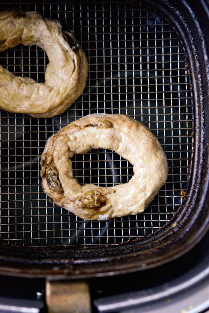 bagel placed in air fryer basket.