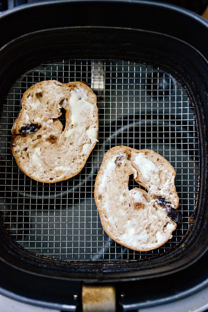 cut bagels slathered in butter get toasted in air fryer
