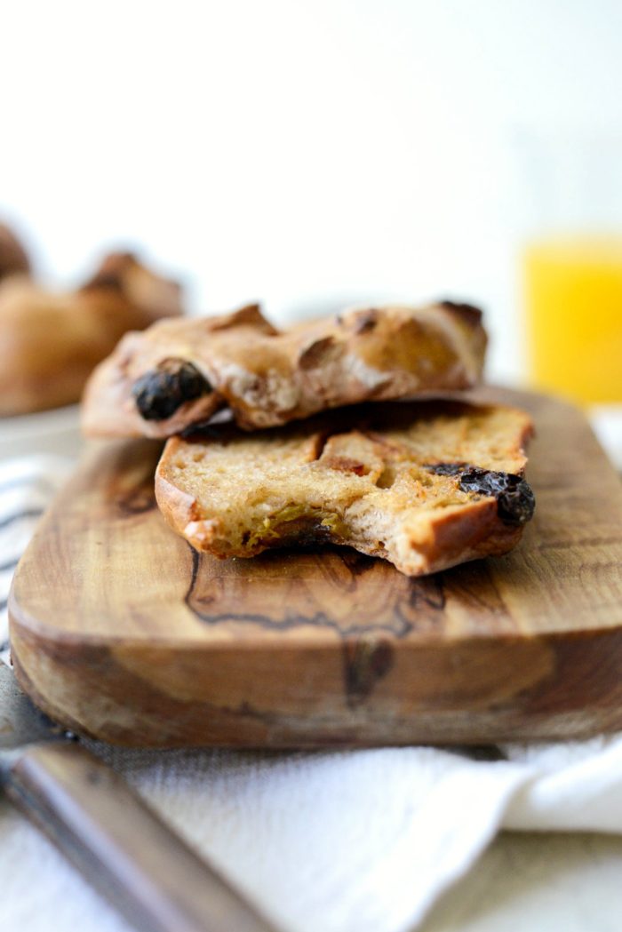 bite missing from buttered and toasted cinnamon raisin bagel.