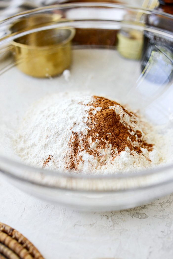 glass bowl of flour, baking powder, cinnamon and salt.