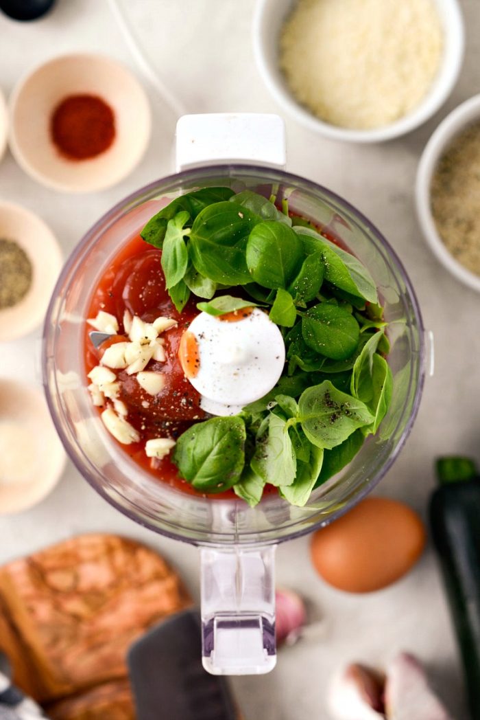 top down shot of ingredients for basil ketchup in mini food processor.