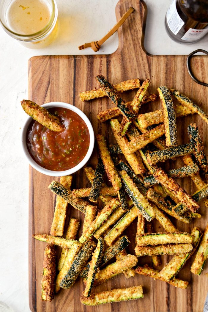 Air Fryer Zucchini Fries - wood cutting board with zucchini fries and basil ketchup.