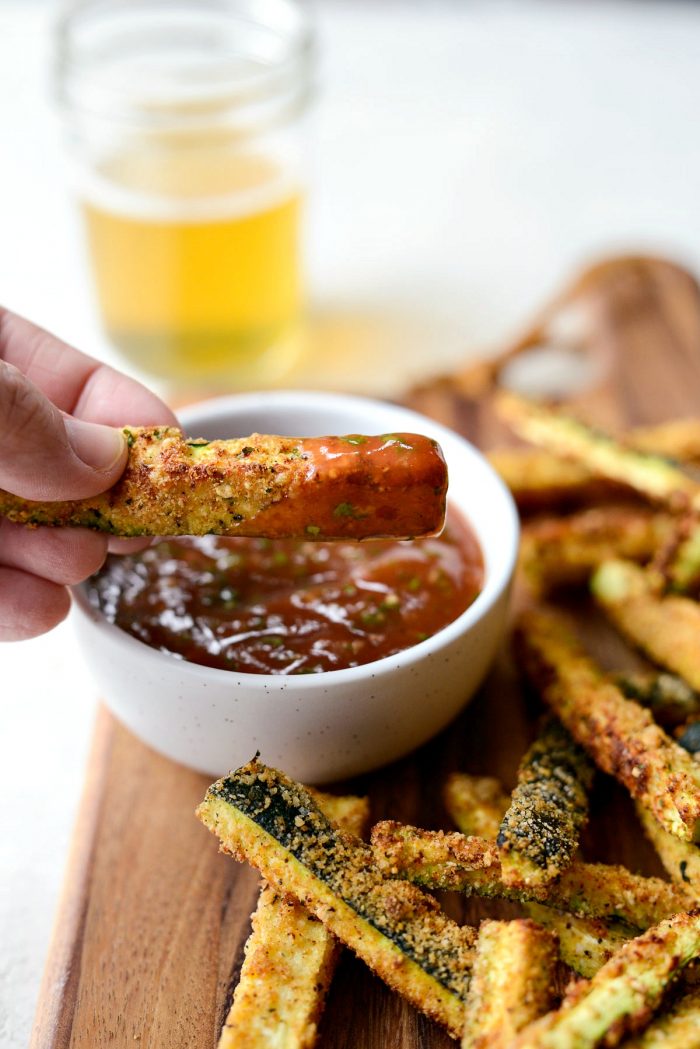 Air Fryer Zucchini Fries - close up of crispy air fryer zucchini fry with basil ketchup