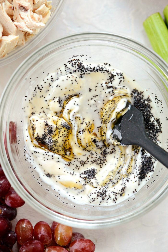 stirring salad dressing with black spatula.