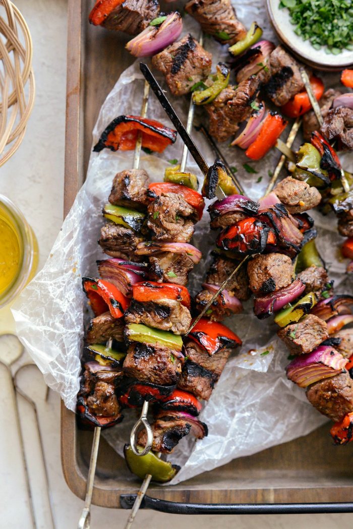 grilled marinated steak kebabs on wooden tray