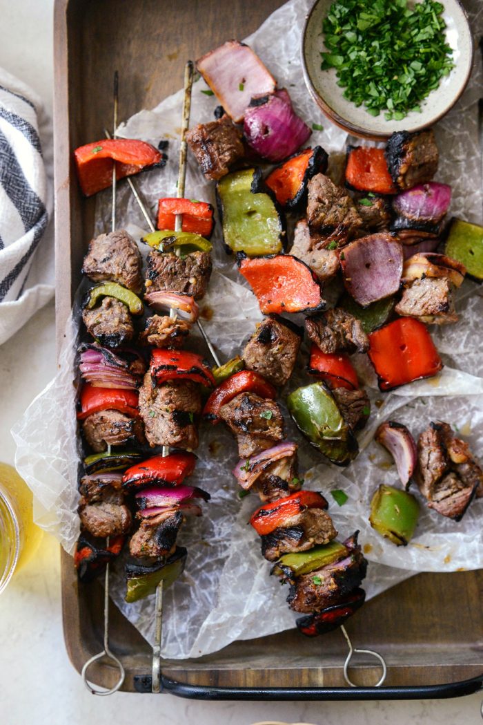 close up of steak kebabs on and off the skewer.