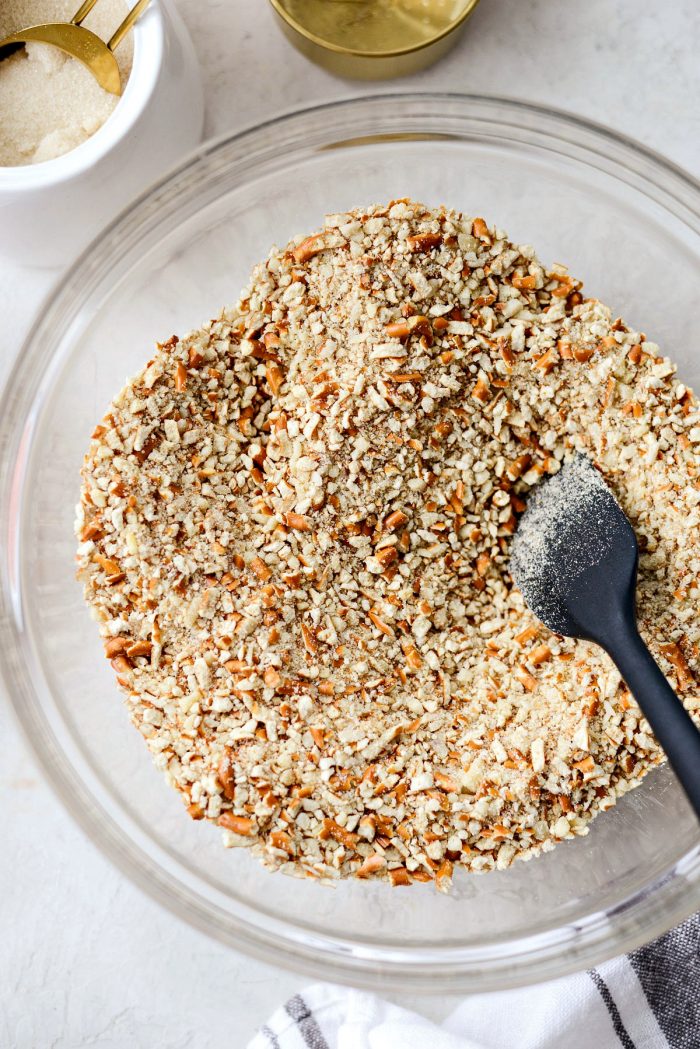 clear bowl of pretzel crumbs, ground almonds and sugar.