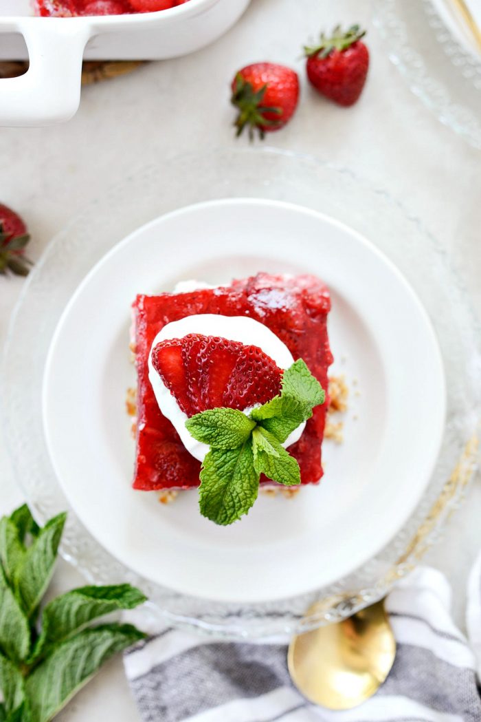 looking top down on a strawberry pretzel dessert bar with whipped cream.