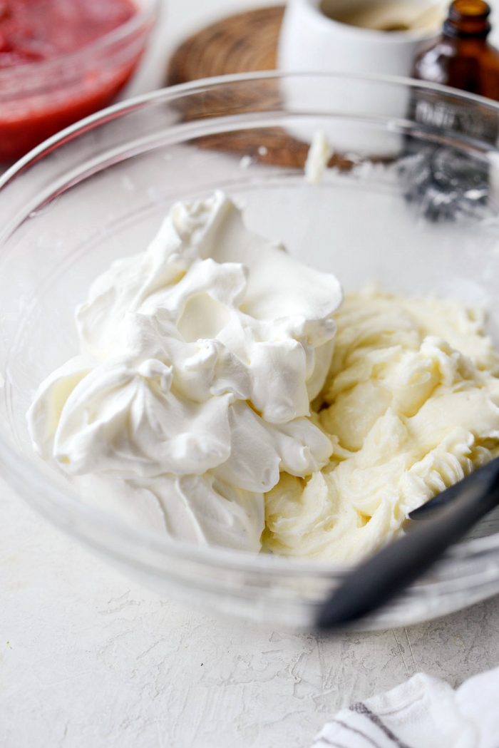 unsweetened whipped cream is added to the bowl with the cream cheese mixture.