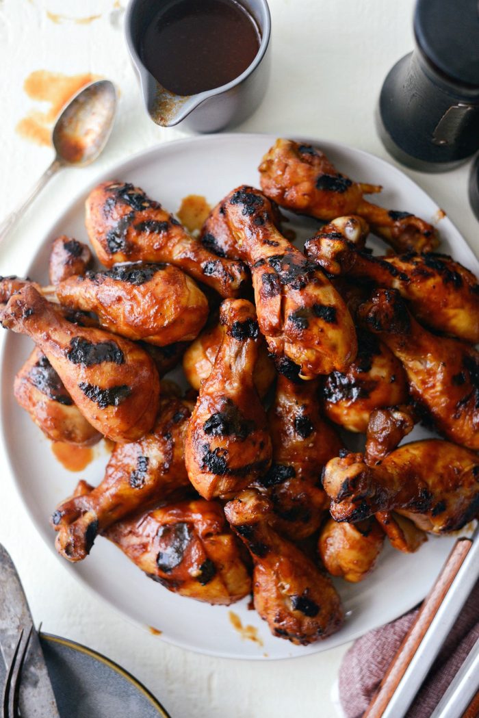 Easy BBQ Chicken Drumsticks on round platter.