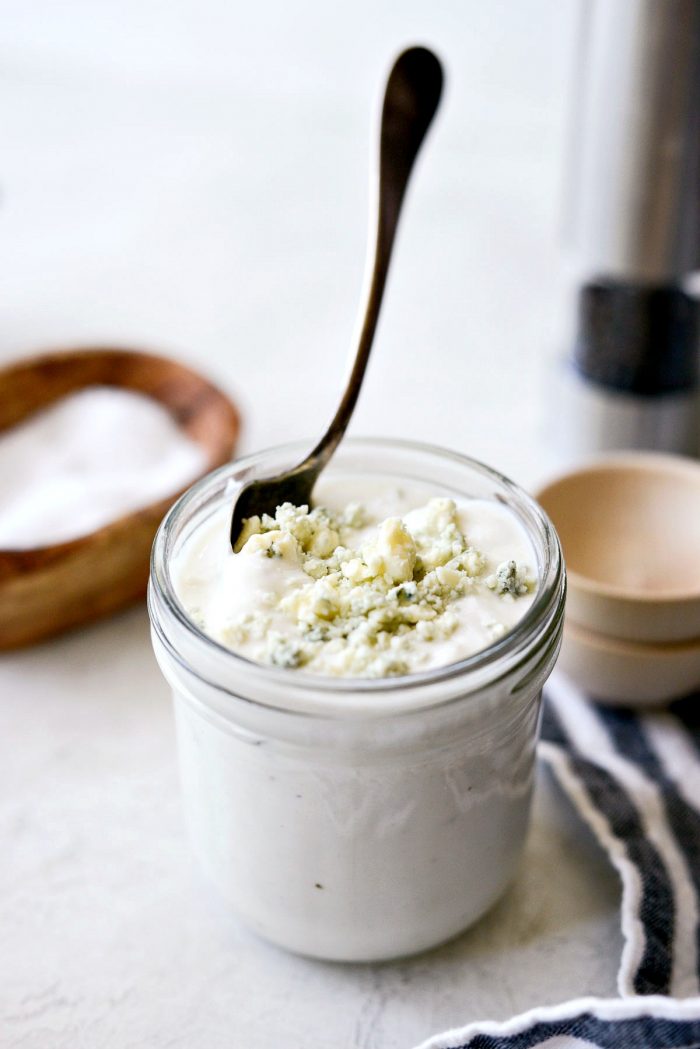 spoon in jar of greek yogurt blue cheese salad dressing