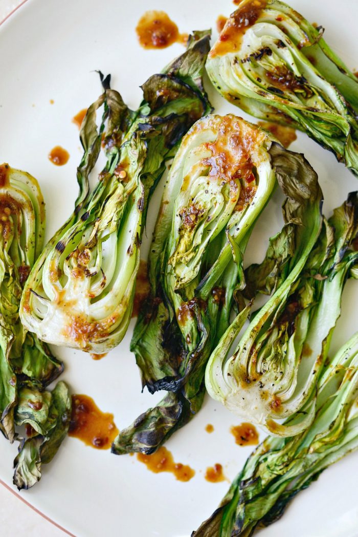 Served grilled baby Bok Choy on a cream platter.