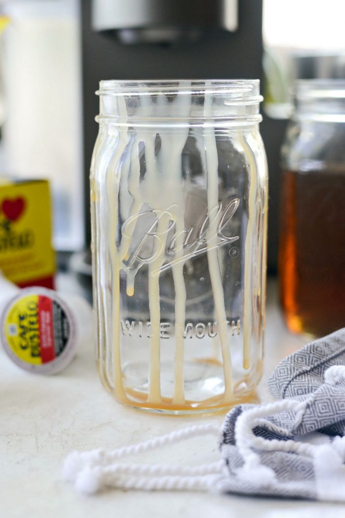 glass jar with caramel drizzle inside.