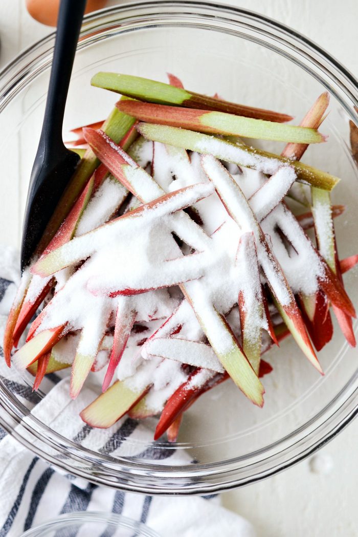 sliced rhubarb and sugar in bowl.