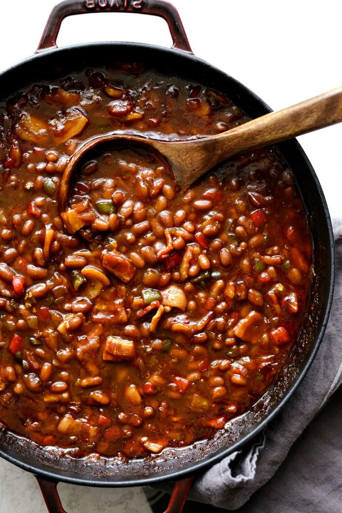 wooden spoon in red pot with one pot wicked baked beans
