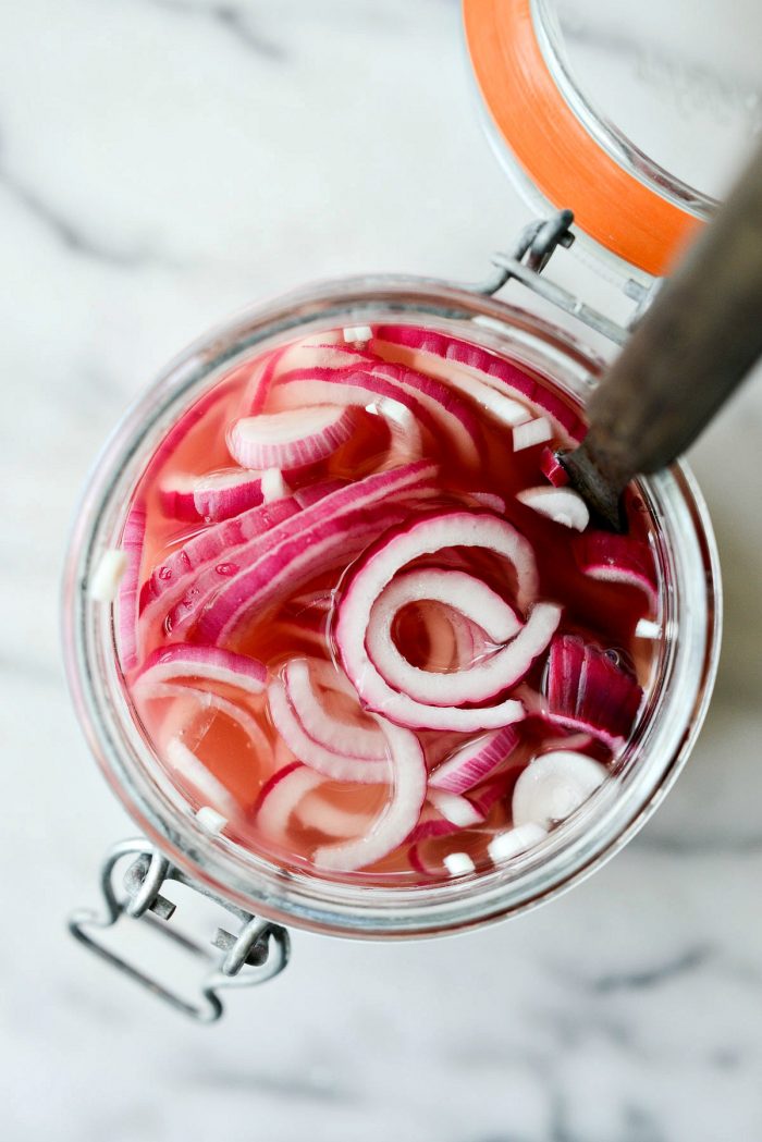 fork in jar of quick pickled red onions.