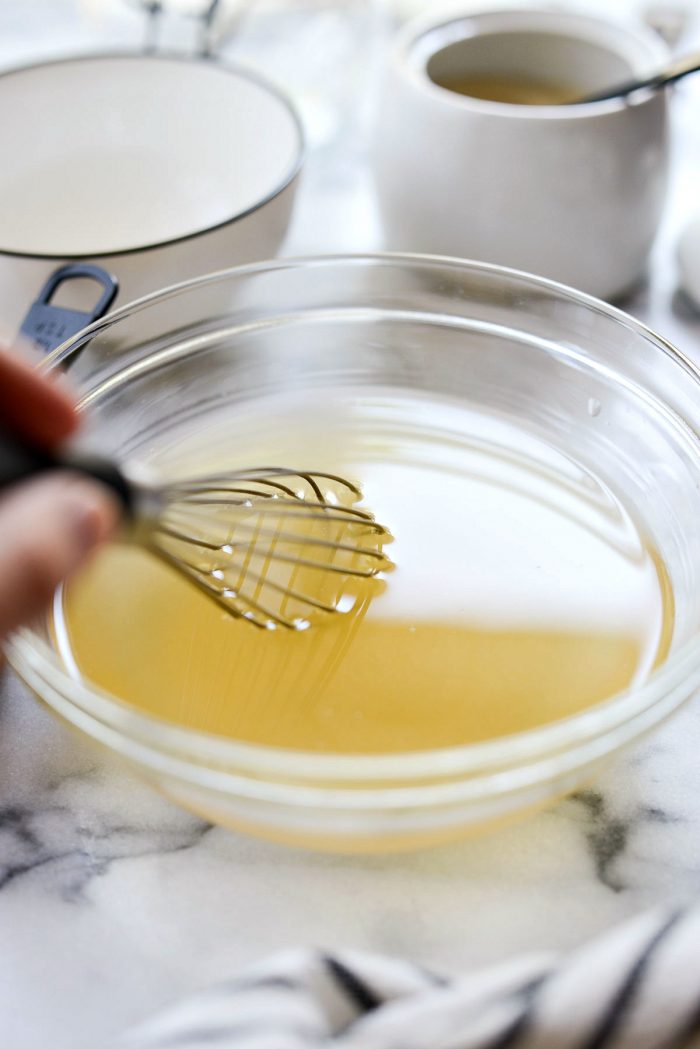 whisking vinegar and water.