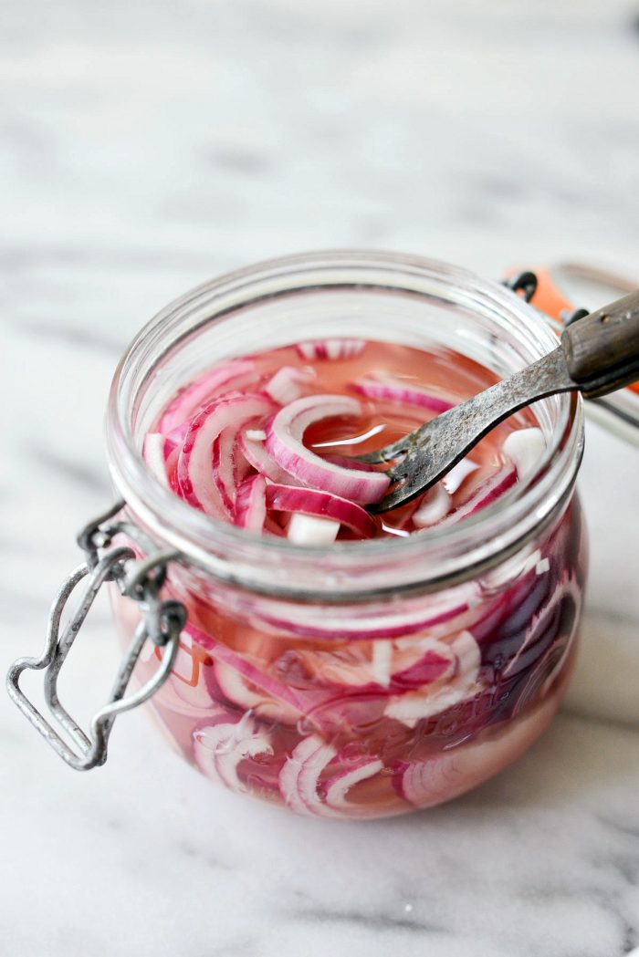 forkful of quick pickled red onions.