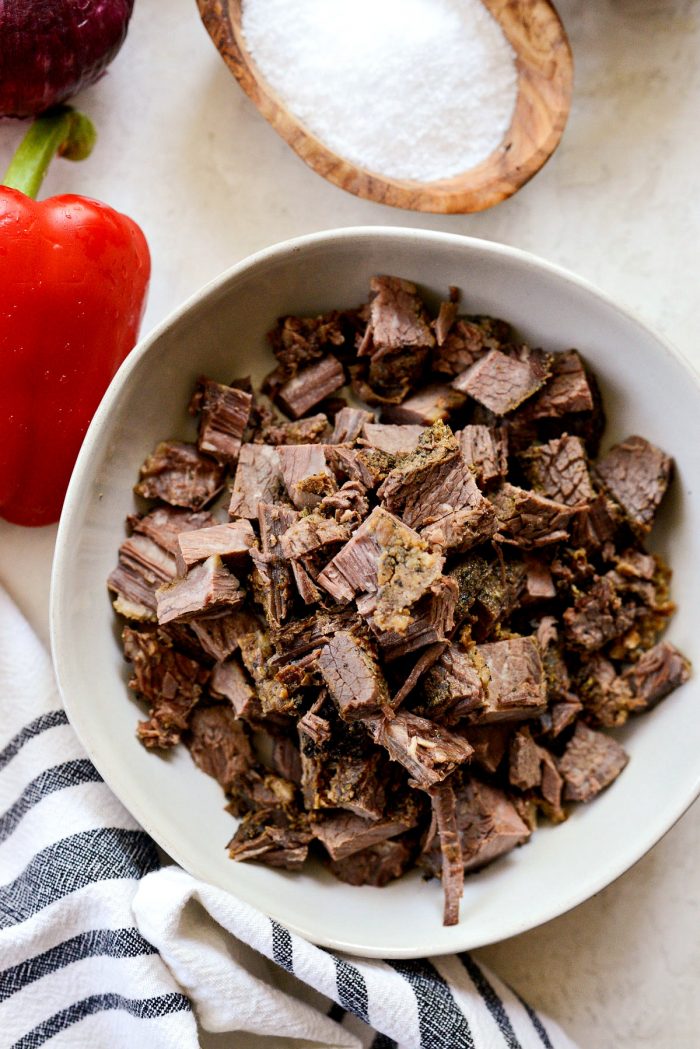 Leftover smoked brisket diced in a cream bowl.