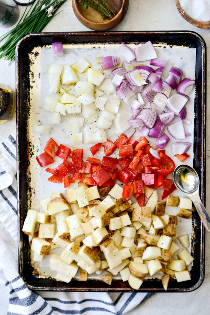 diced russets, red pepper and onions on a sheet pan.