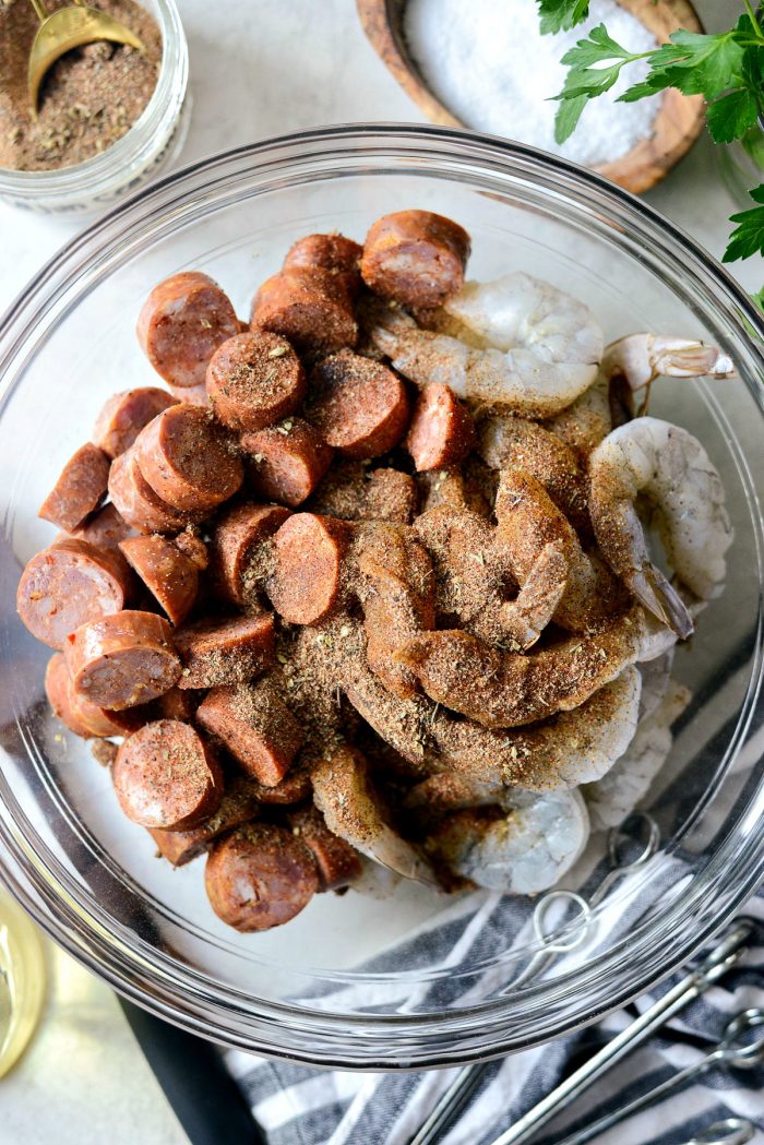 shrimp, andouille, olive oil and homemade cajun spice in a bowl