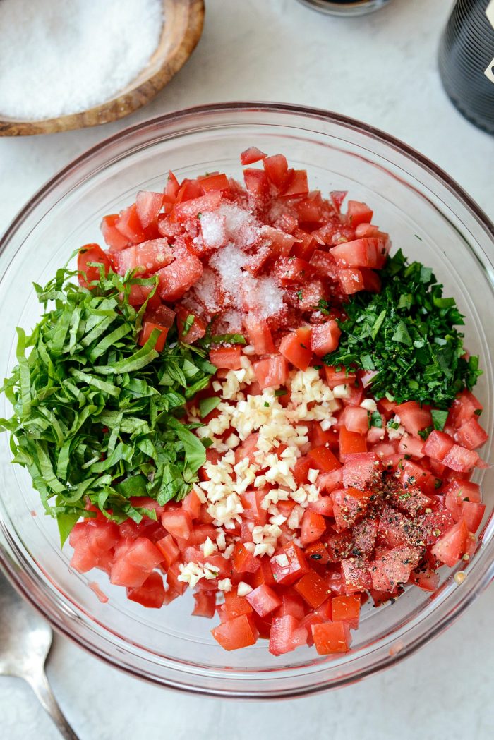 seeded diced tomatoes, garlic, basil, parsley and s & p in glass bowl.